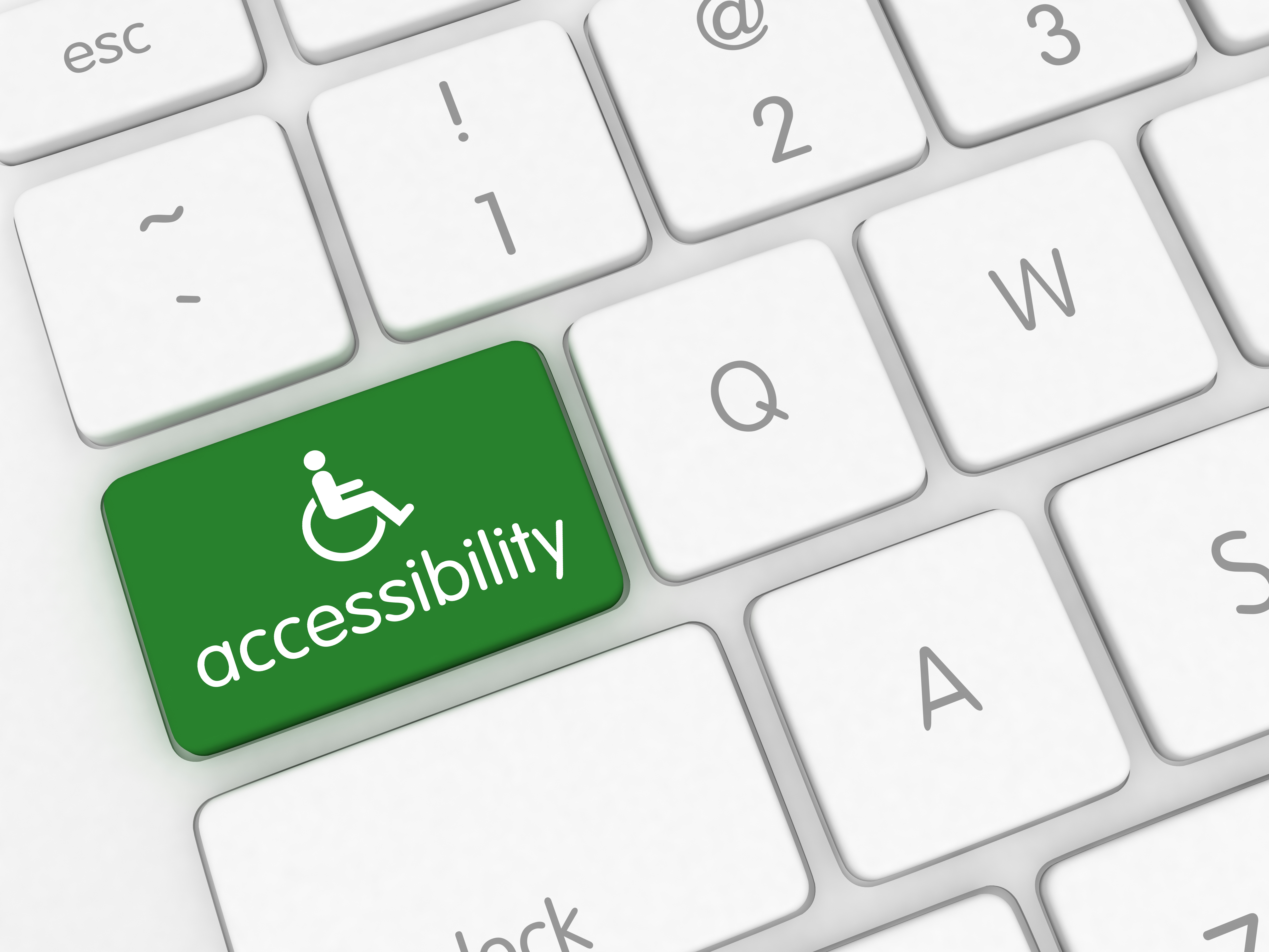 Close up of keyboard keys and one key is labeled accessibility with the wheelchair symbol