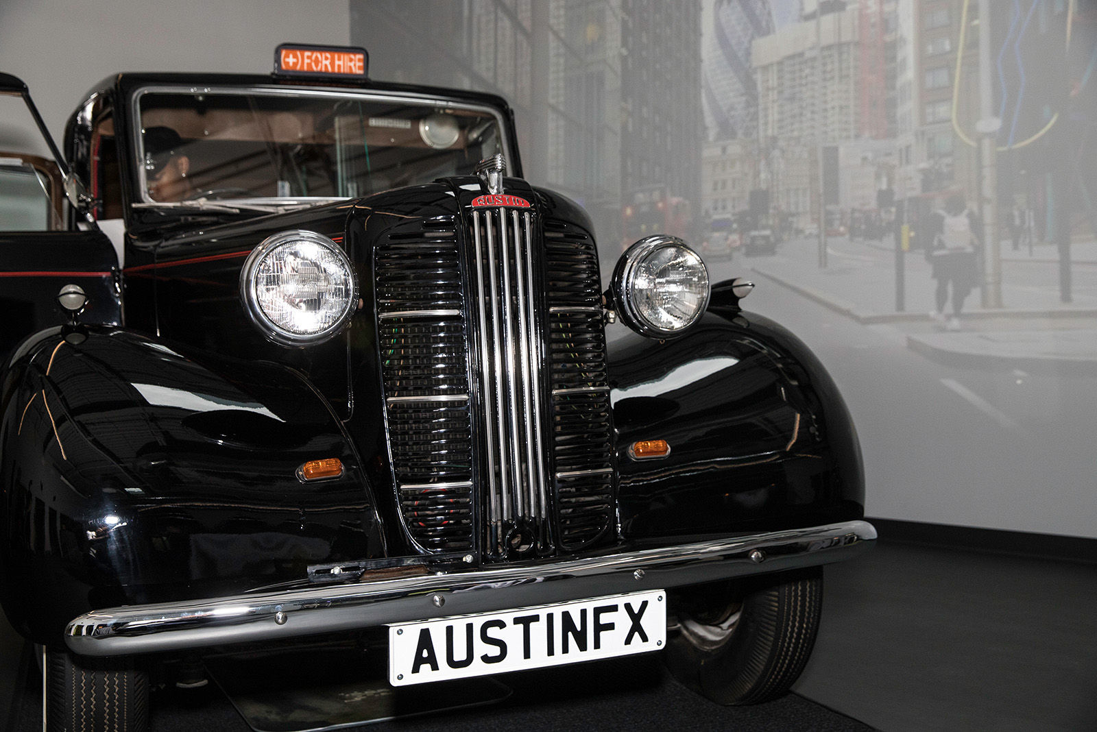An antique London taxi cab inside the offices of (add)ventures.