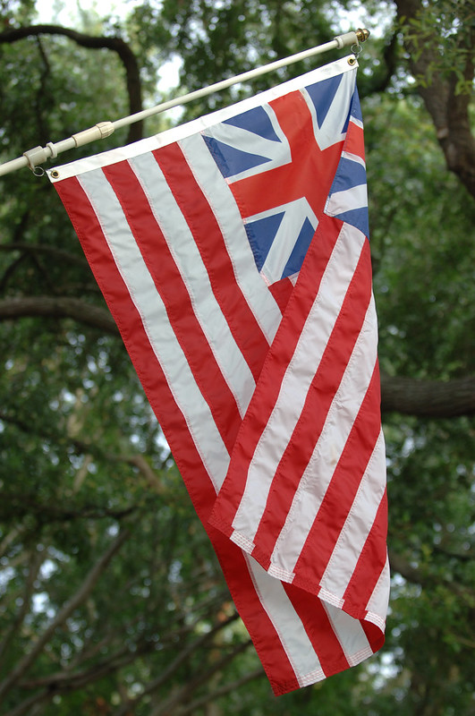 A picture of a Grand Union Flag hanging on a flagpole.