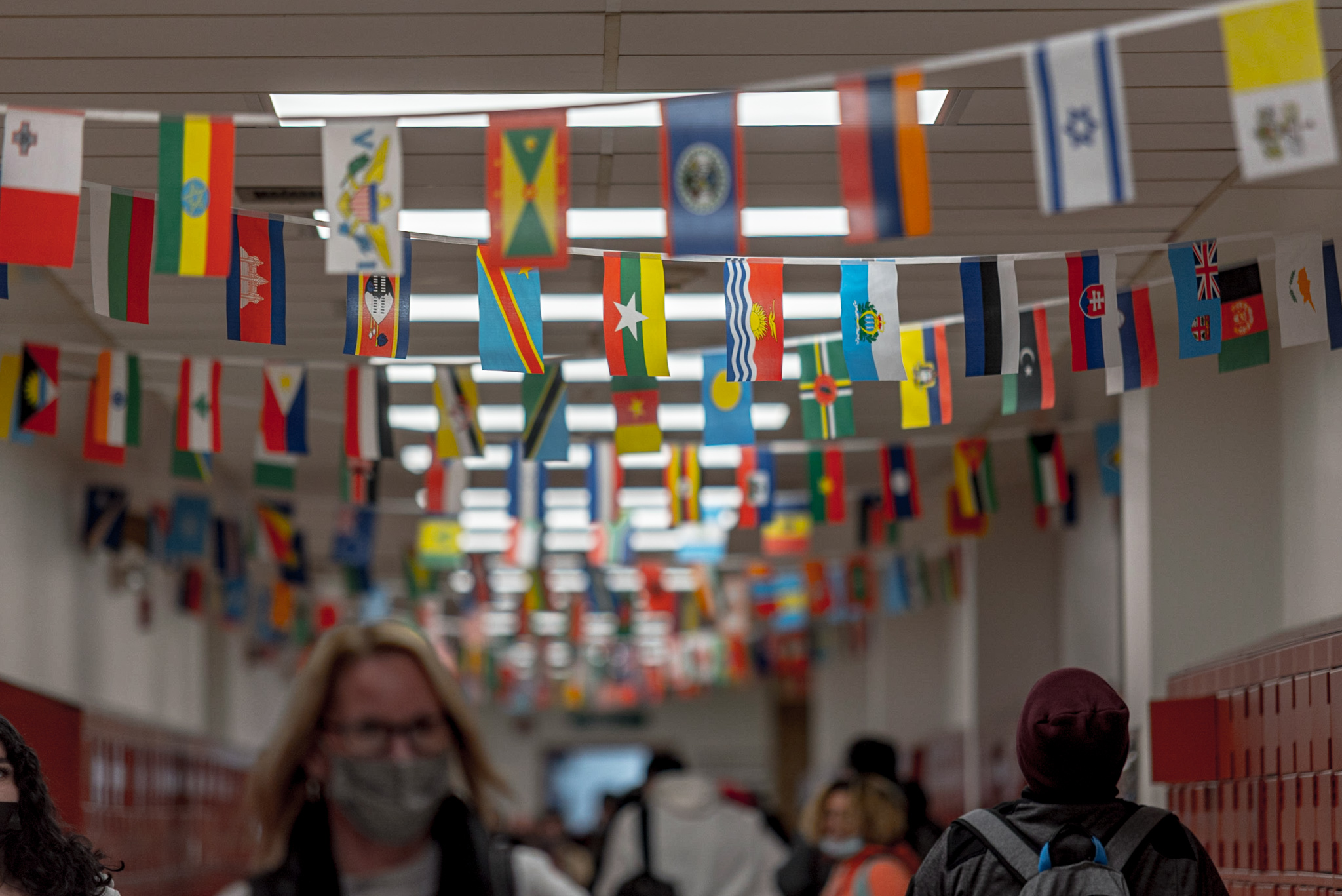 A school hallway with flags strung across the walkway.