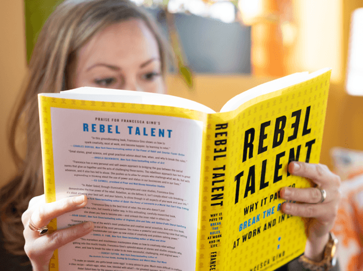 Caucasian woman reading the book “Rebel Talent” by Francesa Gino