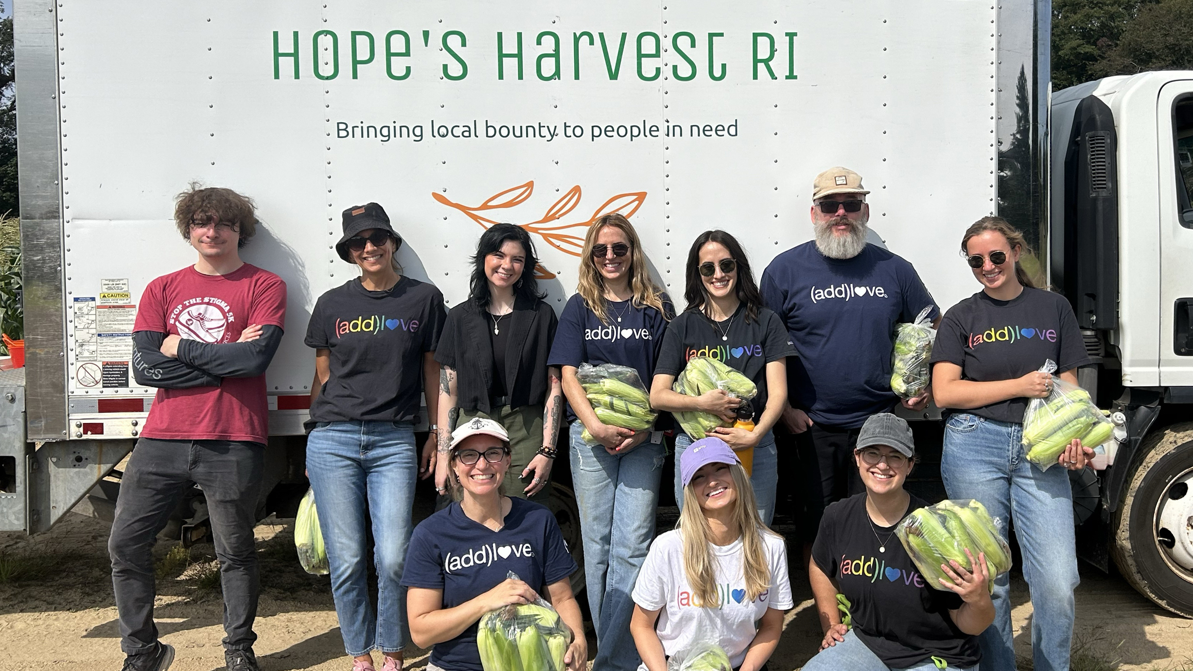 Addventures employees with Hope's Harvest truck behind them