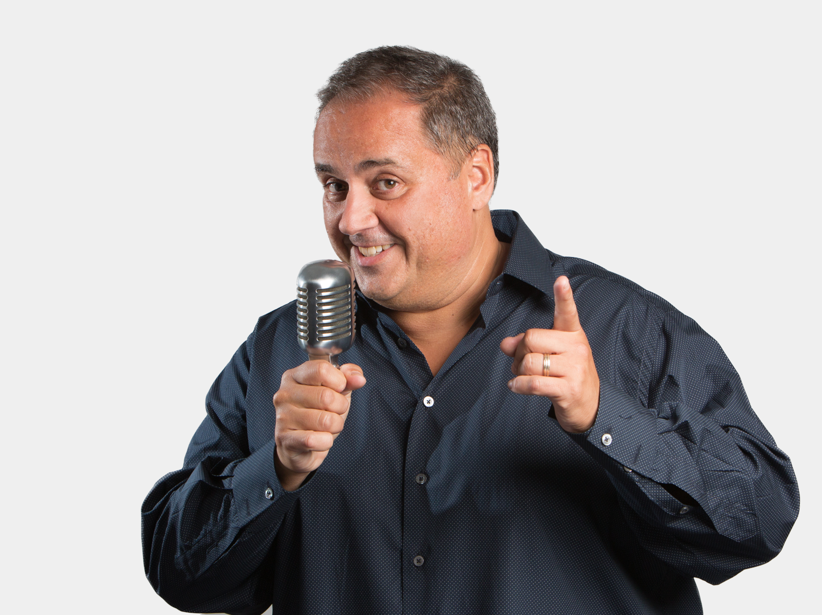 Steve Rosa holding a microphone against a white background